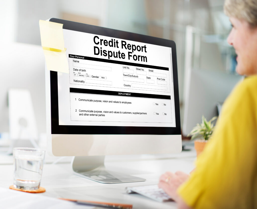 Woman filling out credit report dispute form online